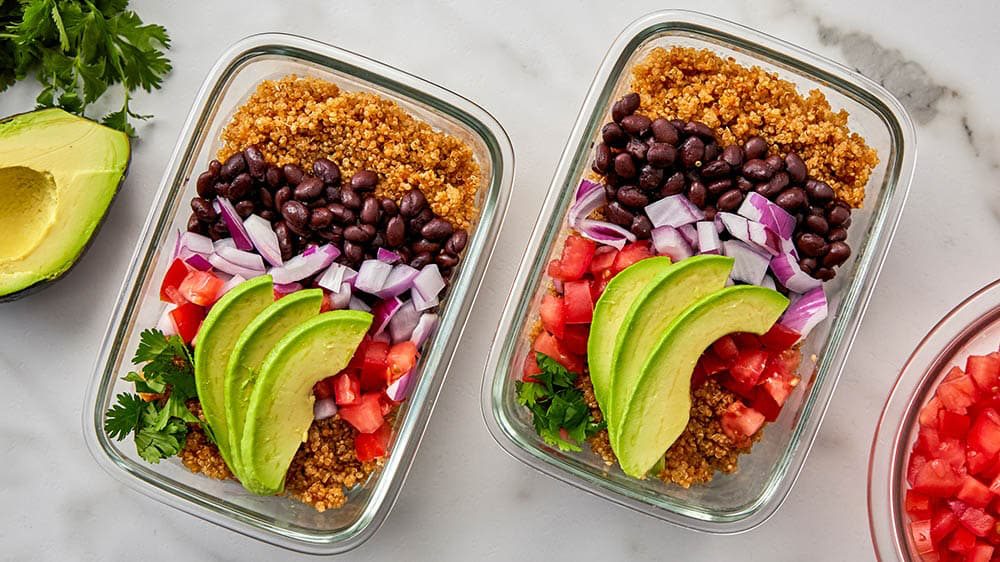 Colorful meal prep containers with variety of proteins and vegetables