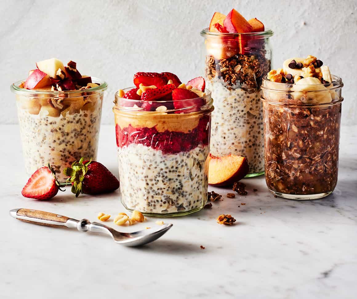 Mason jars of overnight oats with berries and toppings